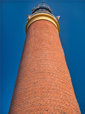 The 37 metre red brick tower of the Butt of Lewis Lighthouse at the most northerly point of the Isle of Lewis, Outer Hebrides, Scotland, UK. Taken on a sunny day.