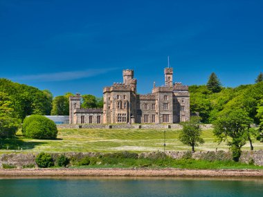The frontage of the category A listed building Lews Castle in Stornoway on Isle of Lewis in the Outer Hebrides, Scotland, UK. Taken on sunny day in summer with a blue sky. clipart