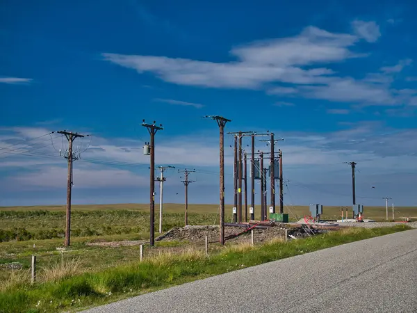 Electricity supply and distribution poles and infrastructure on the Isle of Lewis in the Outer Hebrides in Scotland, UK.