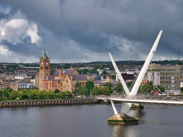 The Peace Bridge across the River Foyle in Derry - Londonderry in Northern Ireland, UK. The bridge links the 