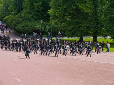 Oslo, Norway - Jun 12 2024: The band leading the changing of the guard ceremony at the royal palace in Oslo, Norway. Taken on a sunny day in summer. clipart