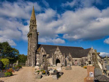 Berrien, France - Sep 17 2024: The church of St Peter - Eglise Saint Pierre - in Berrien, Brittany in northern France. Taken on a sunny day in summer. clipart