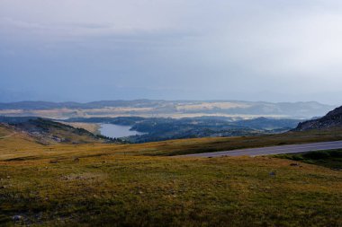 Scenic view of Frozen Lake and the mountains taken from Beartooth Highway in Wyoming during summer. clipart