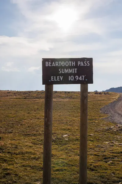 stock image Vertical image of Beartooth Pass sign on scenic Beartooth Highway 212 in Wyoming during summer.