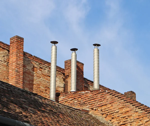 stock image Smoke stacks on the roof of a house