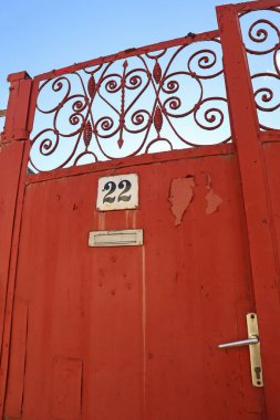 Old red metal door of a house