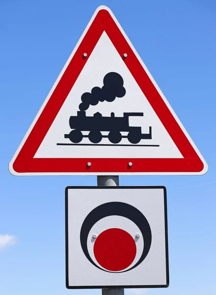 stock image Train crossing road sign against blue sky