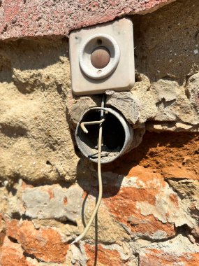 Hasarlı tuğla duvarda çan düğmesi