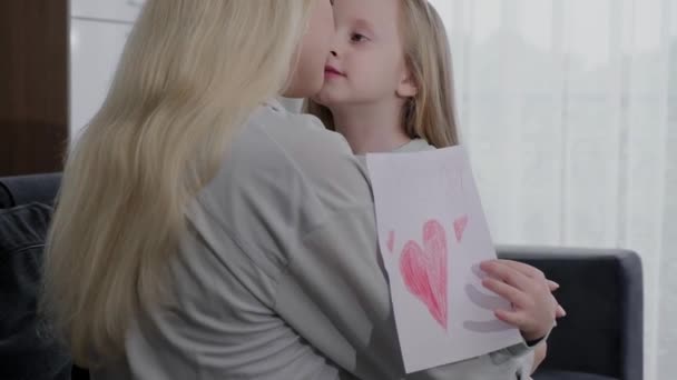 Loving Young Mother Hugs Daughter Who Gave Her Handmade Card — Stock Video