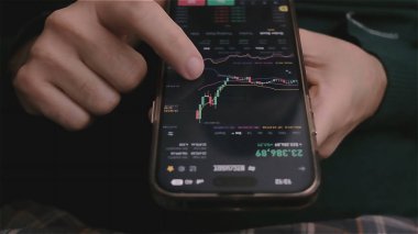 online investor checking Bitcoin, Ethereum cryptocurrency price trends on mobile phone screen, cryptocurrency future price analyze concept.