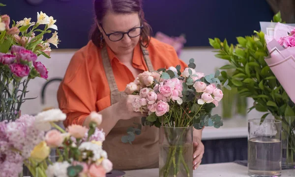 stock image decorations and arrangements floral design studio, the talented female business owner uses her creative expertise to craft a breathtaking bouquet of vibrant blooms