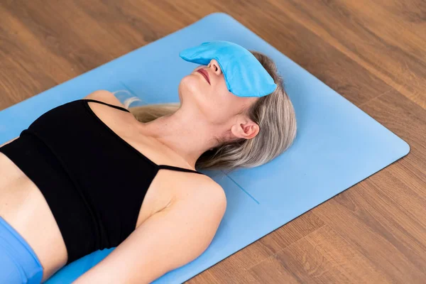 Blonde Woman Lying Blue Mat Silk Aromatic Pillow Relaxation Yoga — Stock Photo, Image