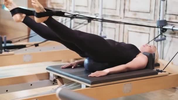 Effective Pilates Exercise Gym Blonde Woman Lying Inflatable Ball Reformer — Stock Video