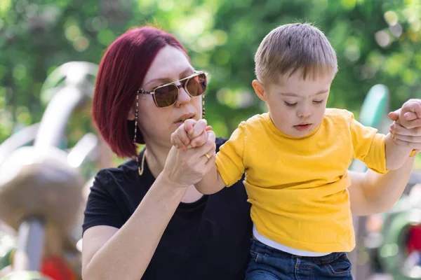 Opiekuńcza Matka Okularach Przeciwsłonecznych Trzymająca Się Ręce Małego Synka Zespołem — Zdjęcie stockowe