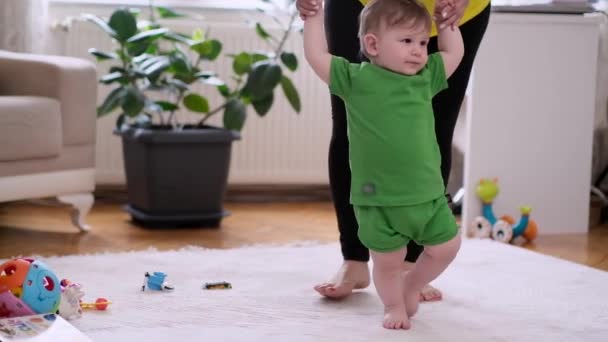 Happy Little Boy Green Outfit Holding Mother Hands Learning Make — Stockvideo