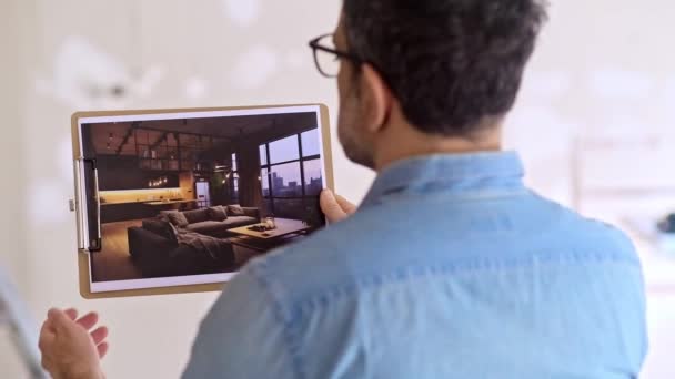 Man Examining Picture Loft Style Interior Design Stands Unfinished Room — Stock Video