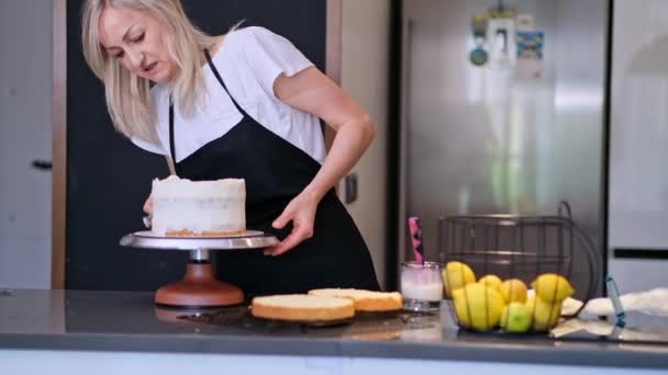 Focused Blonde Confectioner Spreading White Cream Cake Layers Cooking Brush — Stock Video