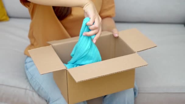 Woman Excitedly Unboxes Delivery New Fashion Clothes Embracing World Commerce — Stock Video