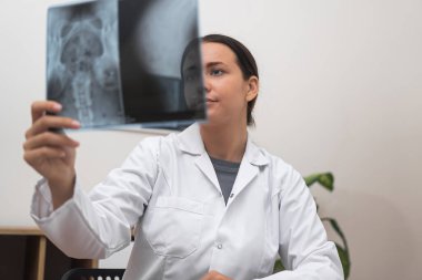 Radyoloji doktorunun hastalarını tuttuğu röntgen filmi sonuçları yorumluyor..