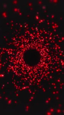 Karanlık bir arkaplanda kırmızı parçacıkların dikey video animasyonu - soyut arkaplan.