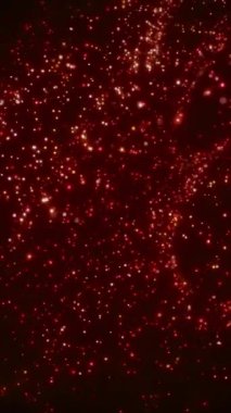 Parlak kırmızı parçacıklar yoğun bir şekilde soyut bir şekilde siyah bir arkaplan üzerinde hareket ediyorlar. Parlayan hareketle enerji dolu dikey canlandırma