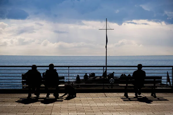 People Sitting Outdoors Bench Looking Sea Royalty Free Stock Images