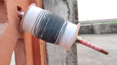 Footage of a charkha shot during sunset. Thread for flying paper kite. Makar Sankranti kite flying festival. Independence Day celebration.