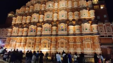 Jaipur, India Circa 2023: Time lapse Footage of Hawa Mahal situated in Pink city shot at night with black sky against dark background. 