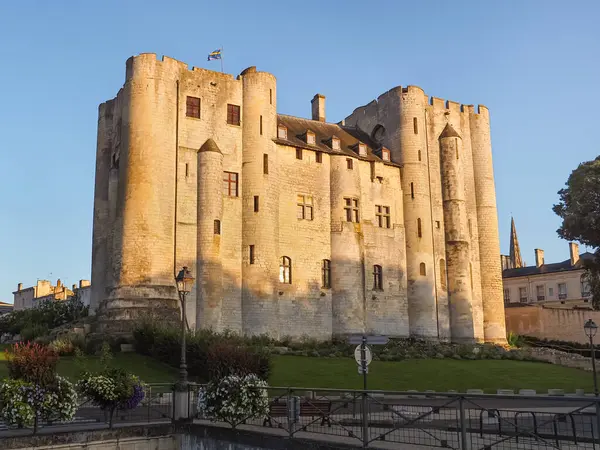 Medieval castle Donjon de Niort, beautiful massive fortress. 15th-century building dominates in the Sevre Niortaise valley. Beautiful stone masonry Romanesque architecture. Niort, France.