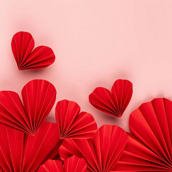 Passion love red hearts of chinese paper fans soar on pastel pink color as  Valentines day background, square, footer border, copy space, top view.