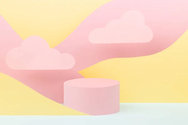Modern vapor wave style stage mockup - pink round podium, pastel mountain landscape - pink, yellow, mint color, clouds. Template for display, show and presentation cosmetic or goods, advertising.