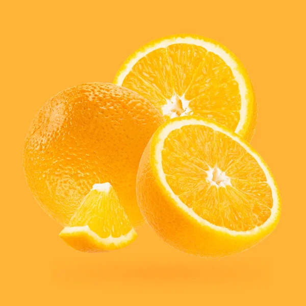 ジューシーなオレンジのクローズアップは アートの構成として飛ぶ パステルオレンジ色のバックグラウンドに全体 半分とピースのフルーツ デザイン ラベル製品のための夏のフルーツ — ストック写真