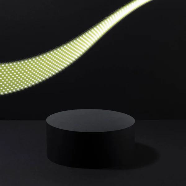Abstract one black round podium with glowing neon yellow light line as motion trail for cosmetic products, mockup on black background. Black stage template in party style for showing products.