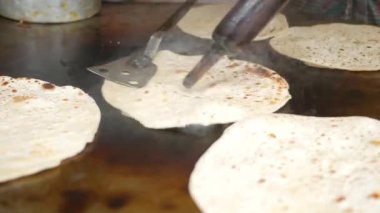  cooking roti chapati on a big cooking pan ,