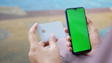  Kadınlar ellerinde kredi kartıyla internet üzerinden akıllı telefon alışverişi yapıyorlar..