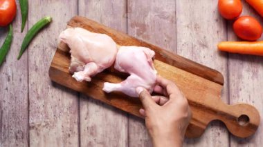 top view of raw chicken leg on a chopping board ,