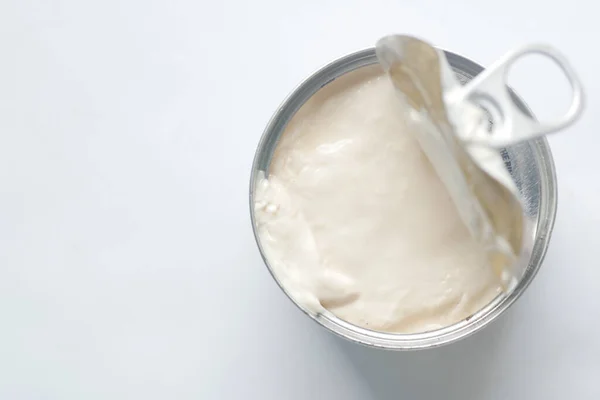 top view of milk cream in a container on table .