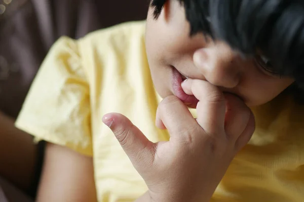 stock image  child girl biting her nails at home