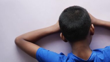 teenage boy head down on desk .