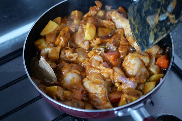 stock image cooking chicken curry in a cooking pan ,