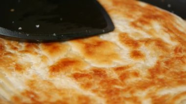  cooking roti chapati on a big cooking pan ,