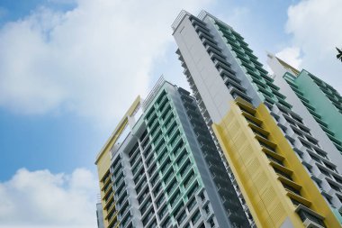 low angle view of signapore residential buildings against blue sky ,