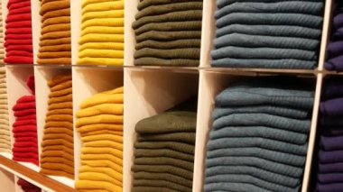 Close up of Colorful Shirts on shelf in a shop ,