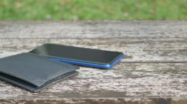  left wallet on a bench in the park ,