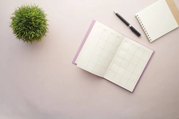 stock image weekly planner and notepad on table .