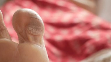 close up of young women dry feet on bed 