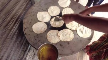  cooking roti chapati on a big cooking pan ,
