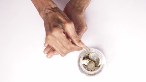 Close Senior Women Hand Saving Coins Jar — Stock Video