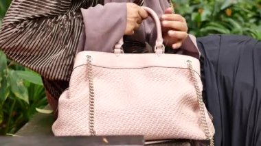 women carrying a pink purse ,