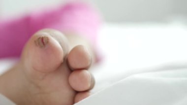 close up of 5 years old child dry feet on bed .